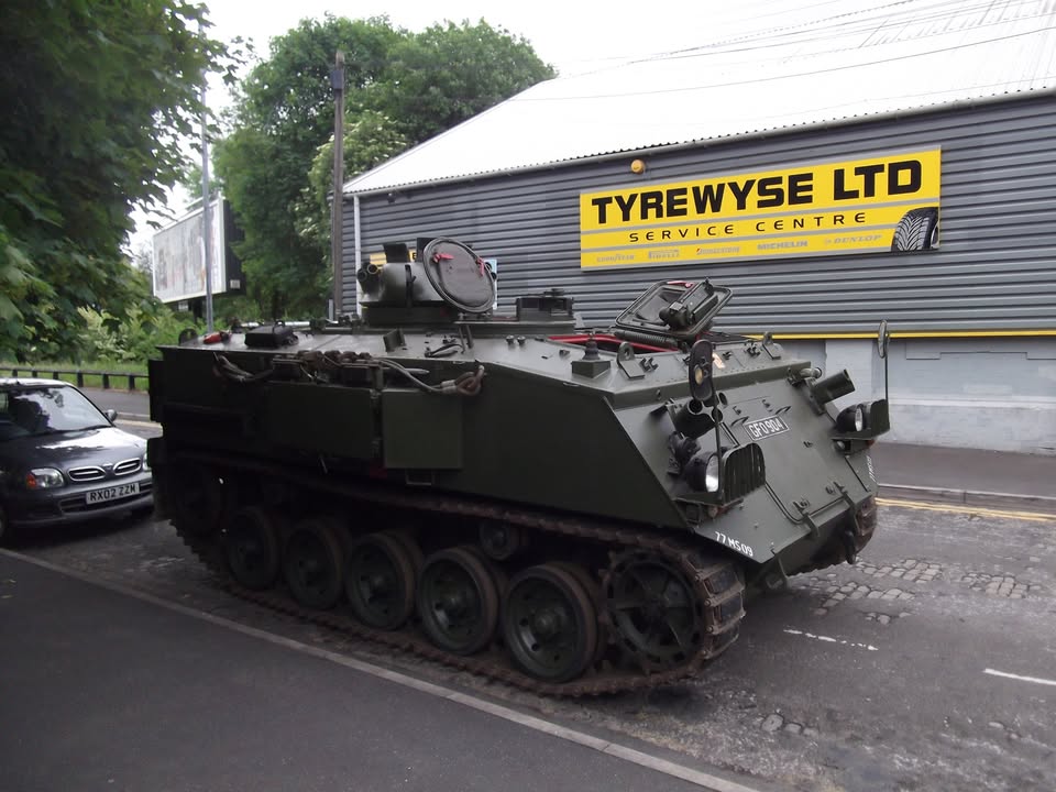 Tyrewyse’s yellow Service Centre sign on Kale Street, with a tracked vehicle outside in a photo from the garage’s Facebook archive